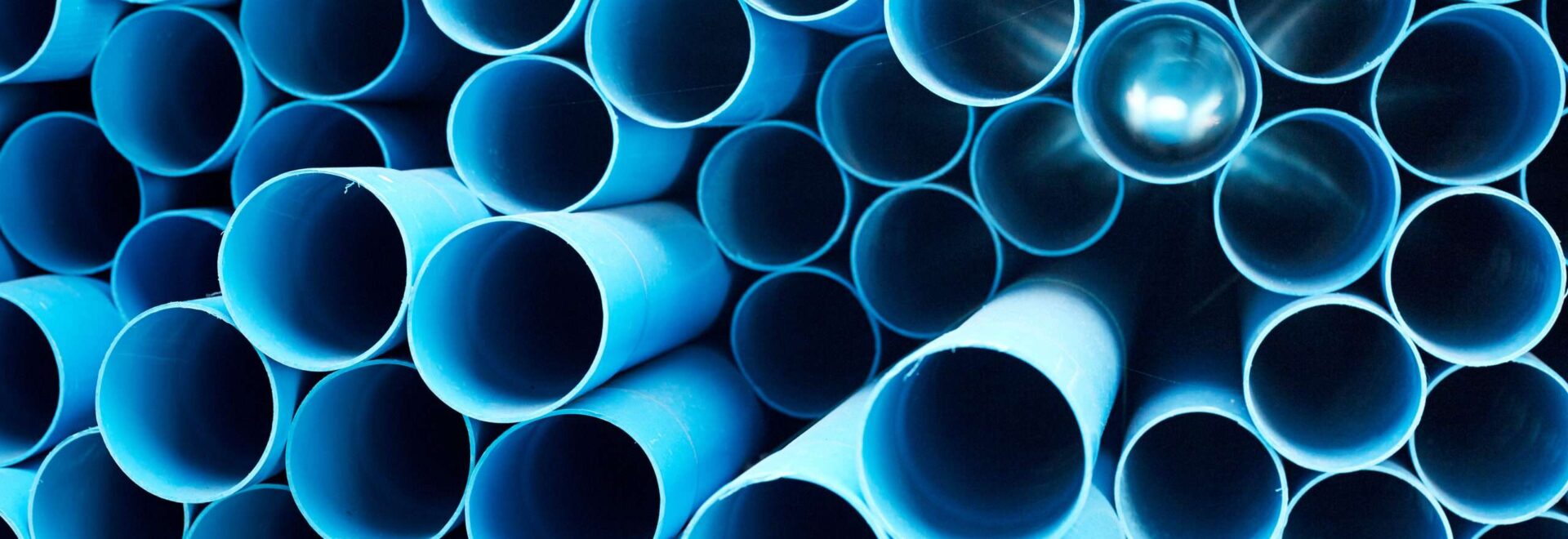 Blue PVC pipes stacked in construction site Types of pipes for plumbing services in San Antonio, TX